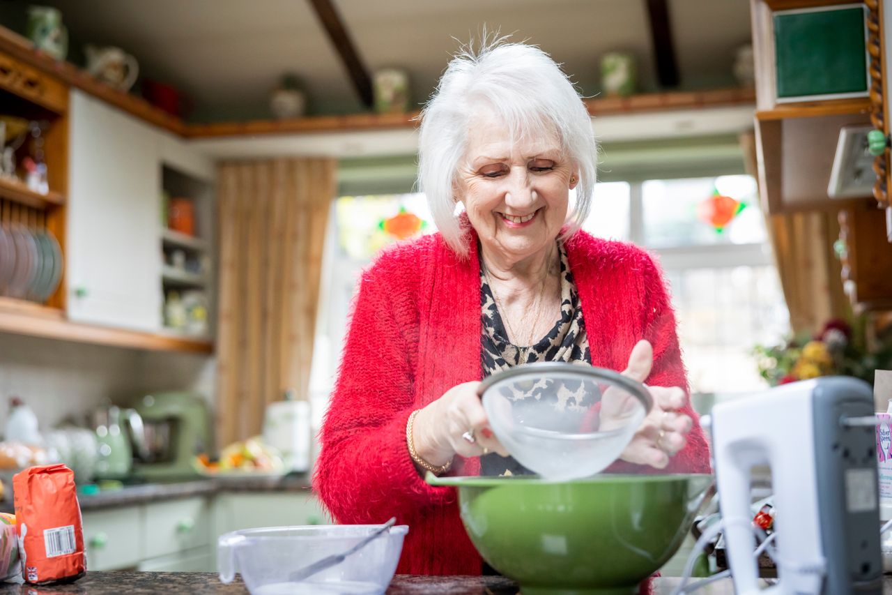 Older lady enjoying baking in the kitchen